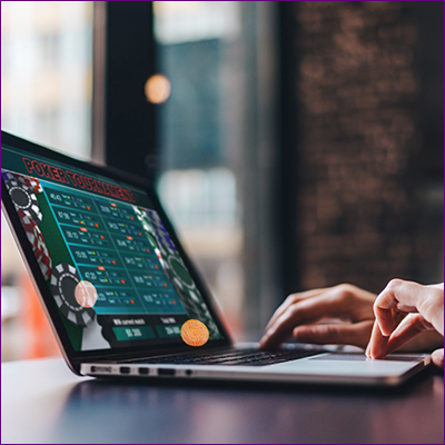 Person playing poker on a laptop